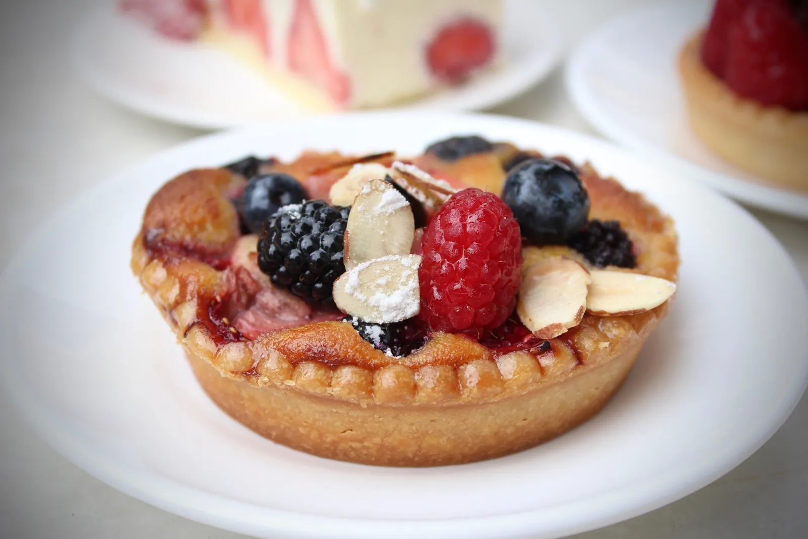 Mixed berry frangipane tart with raspberries, blackberries and blueberries